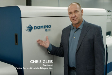 Chris Gleis , President of Factor Forms beside new Domino Label press 