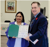 Owner Lakshmi Bhamidipati is presented with a Certificate of Appreciation by Chief Guest Brian Masse, Member of Parliament