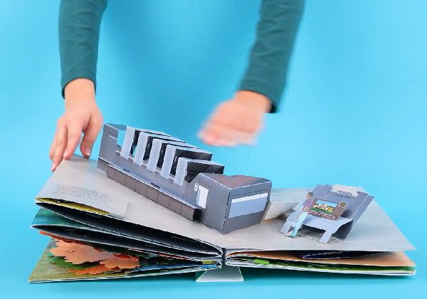 Pop-up book with a press in it 