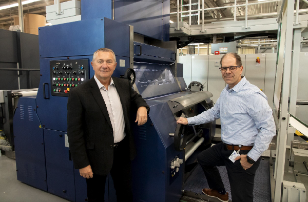 Friesens- Byron Loeppky President, Ryan Hildebrand VP of Trade Books infront of new Timson Web Press.    