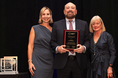PPC President Emily Leonczyk (left) and PPC Board Chair Hilda Murray (right) present Eric Frank (center).